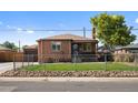 Brick ranch home with a fenced yard and a driveway at 4747 Shoshone St, Denver, CO 80211