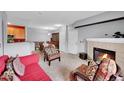 Inviting living room features a cozy fireplace and seamlessly connects to the dining area at 15700 E Jamison Dr # 6-201, Englewood, CO 80112