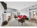 Cozy living room with a decorative fireplace, plush seating, and a sliding glass door to the balcony at 15700 E Jamison Dr # 6-201, Englewood, CO 80112