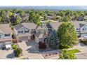 This is an aerial view of a lovely two-story home showcasing its landscaped yard and neighborhood at 9636 W 71St Pl, Arvada, CO 80004