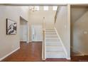 Bright foyer featuring high ceilings, tile flooring, staircase, and a chandelier at 9636 W 71St Pl, Arvada, CO 80004