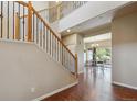 Open foyer area with hardwood floors and staircase leading to the upper level of the home at 9636 W 71St Pl, Arvada, CO 80004