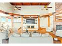 Bright living room featuring vaulted wood ceilings, wood beams, hardwood floors, and a large view window at 2505 Big Bear Cir, Sedalia, CO 80135