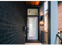 Inviting front entrance features a modern glass door, stylish lighting, and the house number at 2753 Curtis St, Denver, CO 80205