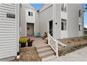 Inviting condo entrance with a small patio, landscaping, and address number 3335 at 3335 S Monaco Pkwy # D, Denver, CO 80222