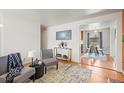 Elegant living room with an open layout, seamlessly connecting to the dining area, perfect for modern living at 10050 W 8Th Pl, Lakewood, CO 80215