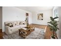 Bright and inviting living room with wood floors, comfortable seating, and neutral decor at 7987 Durango St, Denver, CO 80221