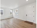 Bright living room with wood-look flooring, large windows, and a modern feel, perfect for entertaining at 5525 Riverbend Ave, Firestone, CO 80504