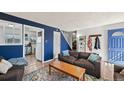 Comfortable living room with modern design elements and an open view of the kitchen at 3095 W Harvard Ave, Denver, CO 80219