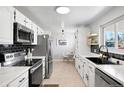 Modern kitchen with stainless steel appliances, ample cabinet space, and a cozy dining area at 7216 S Lincoln Way, Centennial, CO 80122