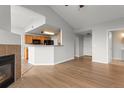 Open-concept living area with hardwood floors, and a glimpse of the adjacent kitchen and entryway, ideal for entertaining at 7440 S Blackhawk St # 207, Englewood, CO 80112