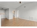 Spacious living room featuring hardwood floors and multiple doorways leading to various parts of the home, enhancing flow at 7440 S Blackhawk St # 207, Englewood, CO 80112