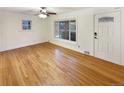 Bright living room with hardwood floors and a large sliding glass door at 1920 Alton St, Aurora, CO 80010