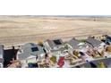 Aerial view of a neighborhood with houses and solar panels at 3158 S Nepal Way, Aurora, CO 80013