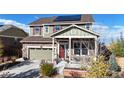 Two-story house exterior with solar panels, landscaping, and a two-car garage at 3158 S Nepal Way, Aurora, CO 80013