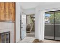 Cozy living room featuring a wood fireplace, tile floors, and sliding glass doors to the outside at 20 S Boulder Cir # 2109, Boulder, CO 80303