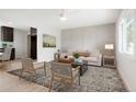 Bright living room features modern decor, light wood floors, and lots of natural light at 13202 Olmsted Pl, Denver, CO 80239