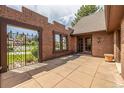 Private outdoor brick patio with wrought iron gate and access to home interior at 5365 W Princeton Dr, Denver, CO 80235