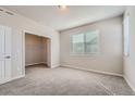 Inviting bedroom featuring soft carpet, a large window, and a spacious walk-in closet at 27752 E 1St Ave, Aurora, CO 80018