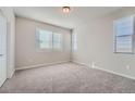 Bright bedroom with neutral walls, plush carpet, and ample natural light from three windows at 27752 E 1St Ave, Aurora, CO 80018