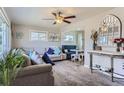 Bright living room featuring a ceiling fan, comfortable sofas, and stylish decor accents with natural light at 841 N Oakland St, Aurora, CO 80010