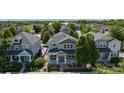 An aerial view showcases this home with its well-manicured lawn and solar panels, nestled in a vibrant neighborhood at 9530 Gray St, Westminster, CO 80031