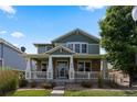 Charming two-story home featuring a welcoming front porch and professionally landscaped front yard at 9530 Gray St, Westminster, CO 80031