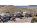 Aerial view showcasing a neighborhood featuring well-manicured lawns and mountain views in the background at 310 S Snowmass Cir, Superior, CO 80027