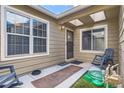 Inviting front porch with seating area, rug, and stylish decor at 10510 W Fair Ave # A, Littleton, CO 80127