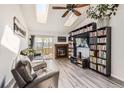Bright living room with vaulted ceilings, skylights, a fireplace, and a sliding door to a deck at 10510 W Fair Ave # A, Littleton, CO 80127