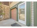 Welcoming front entrance of townhome with a storm door and a one car garage at 12031 E Ford Cir, Aurora, CO 80012