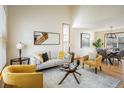 Cozy living room with bright, neutral decor, with a modern glass table, and an open layout with a dining space at 4565 Pussywillow Ct, Boulder, CO 80301