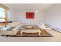 Living room with sectional sofa and large granite-top coffee table at 11052 Zephyr St, Broomfield, CO 80021