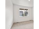 Bedroom with carpet, base-molding and a large window for natural light at 13465 Valentia Pl, Thornton, CO 80602