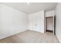 Bedroom with carpet, a closet with double doors and an entrance to another room at 13465 Valentia Pl, Thornton, CO 80602