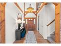 Bright entryway with wood floors and a wood staircase at 13326 Kuehster Rd, Littleton, CO 80127