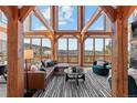 Bright living room featuring exposed beams, mountain views, and a striped rug at 13326 Kuehster Rd, Littleton, CO 80127
