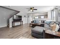 Open living room boasts modern gray walls, neutral floors, and a plush sectional at 7840 Ogden Ct, Denver, CO 80229