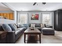 Spacious living room with an expansive sectional sofa and bright natural light at 7840 Ogden Ct, Denver, CO 80229
