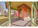 Inviting front porch with a brick facade and decorative railings, perfect for relaxing at 3424 N Marion St, Denver, CO 80205
