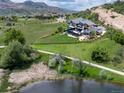 Beautiful home with a fenced yard overlooking a picturesque pond and rolling green hills at 15175 W Belleview Ave, Morrison, CO 80465