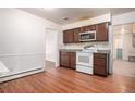 A kitchen featuring a white stove and brown cabinets, ready for modern upgrades at 3306 S Uinta Ct, Denver, CO 80231