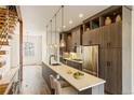 Modern kitchen featuring an island with seating and sleek stainless steel appliances at 2680 Blake St # 4, Denver, CO 80205
