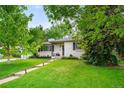 Classic one-story home with brick exterior, landscaped front yard, and a welcoming walkway at 801 S Harrison St, Denver, CO 80209