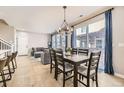 Bright dining area featuring a stylish chandelier and access to the backyard at 10246 Tall Oaks Cir, Parker, CO 80134