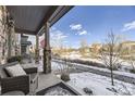 View from the porch showcasing a snowy neighborhood and open space at 10246 Tall Oaks Cir, Parker, CO 80134