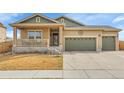 Inviting home with a covered front porch, neutral siding, and a well-maintained front lawn at 9868 Olathe St, Commerce City, CO 80022