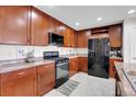 Well-equipped kitchen with stainless steel appliances and sleek dark wood cabinets at 9868 Olathe St, Commerce City, CO 80022