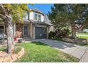 Charming two-story home features a well-manicured lawn and stone accents at 2215 E 103Rd Pl, Thornton, CO 80229