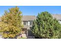 A two-story home with mature trees and a well-maintained yard presents curb appeal at 2215 E 103Rd Pl, Thornton, CO 80229